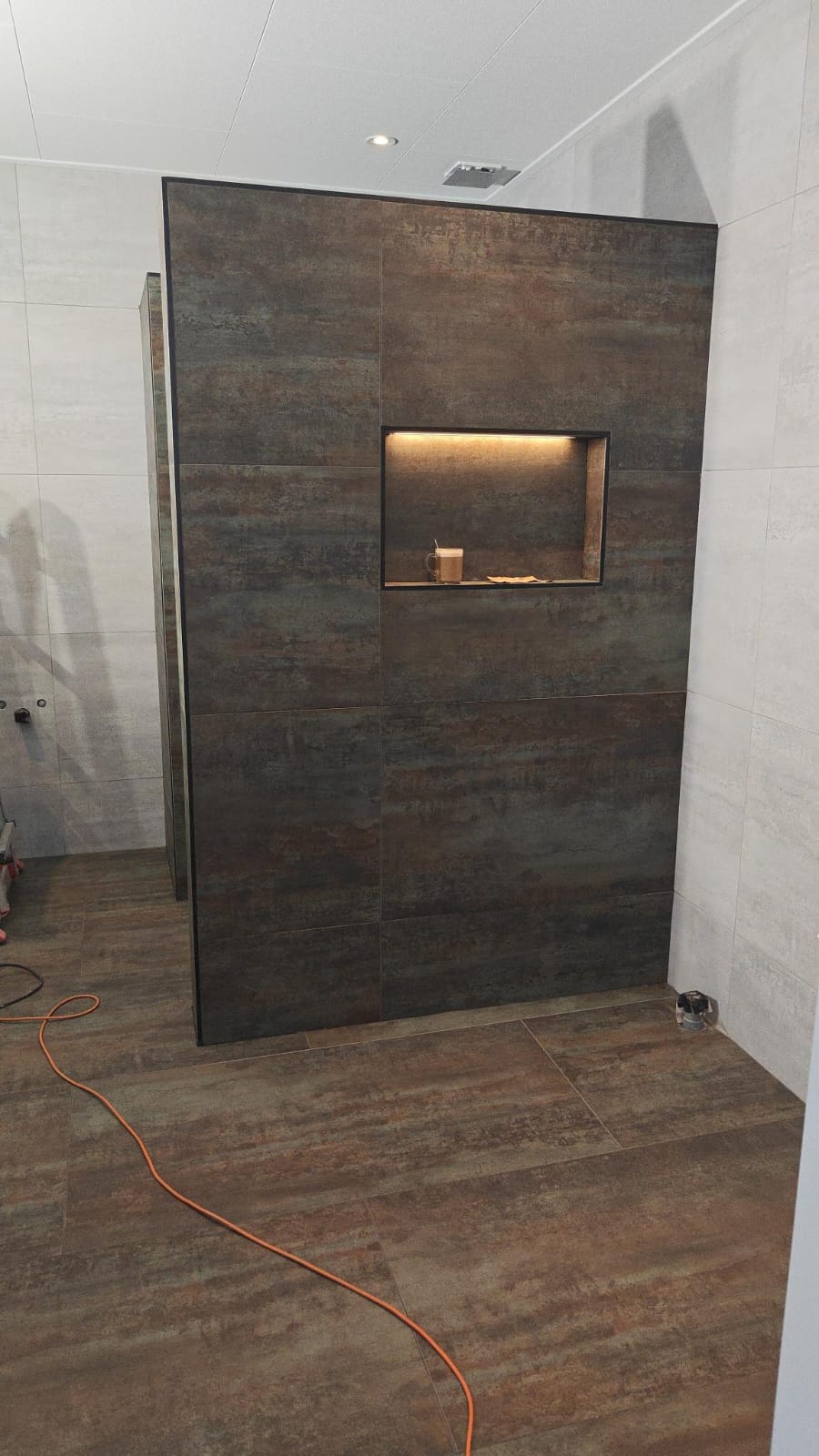 Moderne badkamer met betegelde douchewand